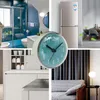 A collage of different home interior scenes, including a bathroom, kitchen, dining area, and living room, with a clock as a central element. Produktbild-Vorschau