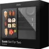 A black box with a clear window showing a sushi set inside. The box has text and a logo. Voir les images du produit