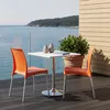 A table and two chairs on a balcony overlooking the sea. Anteprima dell’immagine prodotto