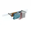A drying rack with clothes hanging on it, mounted on a white railing. Voir les images du produit