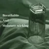 A glass of water with condensation sits on a dark green fabric. Produktbild-Vorschau