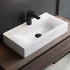 A white rectangular sink with a black faucet is placed on a wooden vanity. Produktbild-Vorschau
