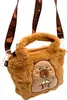 A plush capybara-shaped handbag with a handle and shoulder straps. Produktbild-Vorschau