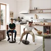 A father and son are sitting on wobble stools in a modern kitchen, with the son smiling at the camera and the father reaching for popcorn. Náhled obrázku produktu