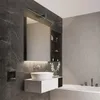 A modern bathroom with a wall-mounted vanity, sink, mirror, and bathtub. Anteprima dell’immagine prodotto
