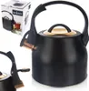 A black and gold whistling kettle is shown on a white background, with its packaging in the upper left corner. Náhled obrázku produktu