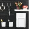 A black pegboard wall organizer with various accessories attached. Náhľad obrázku produktu
