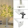 A collage of images showing a decorative LED tree lamp with artificial leaves and lights, along with close-ups of its base and power connection. Produktbild-Vorschau