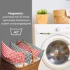 Pillows in a basket next to a washing machine, with care instructions overlaid. Produktbild-Vorschau