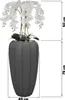 A tall, dark gray vase with a white orchid arrangement inside, with dimensions indicated by measurement lines and text. Voir les images du produit