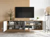 A modern TV stand with open shelves, displaying books and decorative items, in a well-lit room with a slatted wooden wall behind it. Produktbild-Vorschau