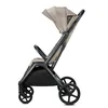 A side view of a beige and gray stroller on a white background. Anteprima dell’immagine prodotto