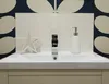 A bathroom sink with a faucet, soap dispenser, and decorative star. Náhled obrázku produktu