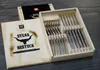 A wooden box containing a set of steak cutlery, with the lid open showing the cutlery inside and branding on the lid. Produktbild-Vorschau