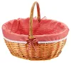A wicker basket with a red and white checkered lining and a bow. Produktbild-Vorschau