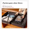 A person is packing a suitcase, with clothes inside. Produktbild-Vorschau