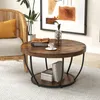 A round coffee table with a wooden top and black metal legs, set in a living room with a chair and artwork. Anteprima dell’immagine prodotto