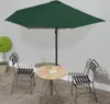 An outdoor patio set with a green umbrella, a round wooden table, and two chairs. Anteprima dell’immagine prodotto