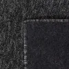 A close-up view of the corner of a rug, showing the texture and the bound edge. Náhled obrázku produktu