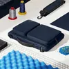 A navy blue laptop bag with accessories like spools of thread and foam padding. Produktbild-Vorschau