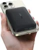 A hand holding a smartphone with a power bank attached to its back. Produktbild-Vorschau