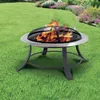 A fire pit with flames burning in a grassy backyard with flowers in the background. Produktbild-Vorschau