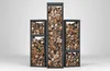 Four tall, narrow, black metal racks filled with firewood, arranged in a staggered height formation against a white background. Podgląd zdjęcia produktu