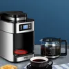 A coffee maker with a carafe of coffee and a cup of coffee on a counter. Produktbild-Vorschau