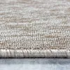 A close-up view of the edge and texture of a beige and brown rug. Produktbild-Vorschau