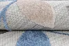 A close-up view of a rolled-up rug, showing its texture and pattern. Náhľad obrázku produktu