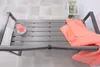 A garden bench with a coral blanket draped over it, placed on a tiled floor. Produktbild-Vorschau