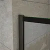 A close-up view of a shower enclosure corner, showing the black frame and glass against a tiled wall. Produktbild-Vorschau