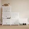 A white modular shoe rack with a cat on top, filled with shoes. Produktbild-Vorschau