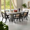 A dining room with an oval table and chairs, set up for a meal. Produktbild-Vorschau