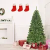 A Christmas tree with presents and decorations in a room. Produktbild-Vorschau
