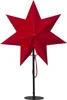 A red star-shaped lamp on a black stand against a white background. Podgląd zdjęcia produktu