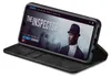 A smartphone in a black flip case is displayed on a white background, showing a movie streaming interface on its screen. Produktbild-Vorschau