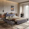 A bedroom scene featuring a bed with storage drawers and a headboard with integrated USB ports, set against a concrete wall. Náhľad obrázku produktu
