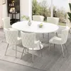 A dining set with an oval table and chairs in a well-lit room with a large window overlooking a garden. Anteprima dell’immagine prodotto