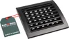 A black ventilation grille with a product tag attached by a red string, set against a white background. Podgląd zdjęcia produktu