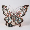 A decorative solar-powered butterfly light with colorful jewel accents. Produktbild-Vorschau