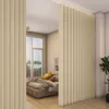 A bedroom with a bed and a partition made of vertical blinds. Produktbild-Vorschau