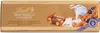 A chocolate bar wrapper with an illustration of chocolate pieces, nuts, berries, and milk being poured. Podgląd zdjęcia produktu