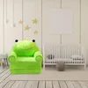 A child's frog-themed armchair is placed in a nursery setting next to a crib. Produktbild-Vorschau