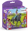 A toy horse and rider set in its packaging, with illustrations of children and horses on the box. Voir les images du produit