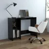 A modern black computer desk with a laptop, lamp, and books, next to a white and brown chair. Náhled obrázku produktu