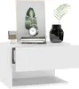 A white bedside table with a drawer and an open shelf, decorated with a framed picture of a leaf, a vintage alarm clock, a glass of liquid, and a black vase with a plant. Produktbild-Vorschau