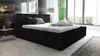 A black upholstered bed with a mattress and pillows in a modern bedroom with large windows. Produktbild-Vorschau