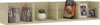 A wooden CD wall shelf with several compartments, displaying books, CDs, and picture frames. Produktbild-Vorschau