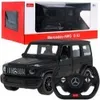 A black Mercedes-Benz G63 AMG toy car with a remote control steering wheel in front of its packaging. Náhľad obrázku produktu